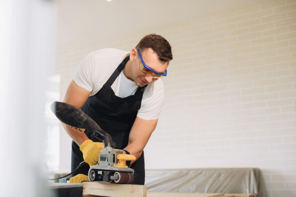 Maintenance man fixing furniture with a special equipment